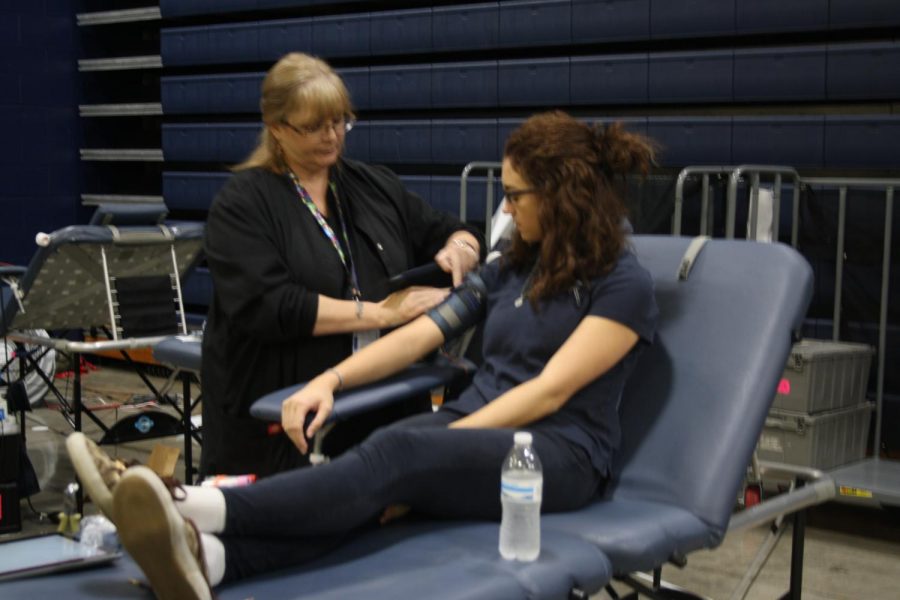 Senior Genna Pieper gives blood at the blood drive. 
Camryn McPherson Photo.