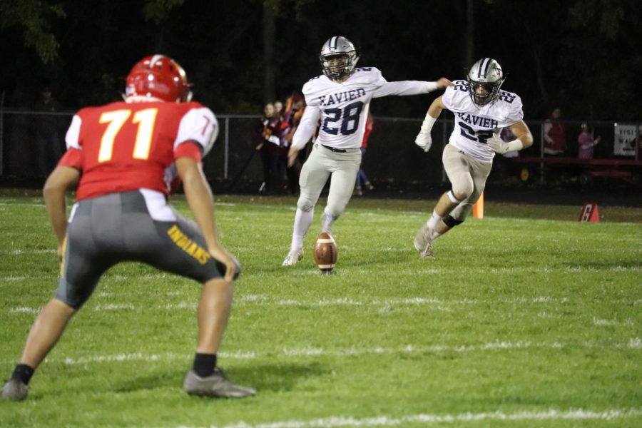 Ben Conrad (#28) kicks the ball during a game against Marion. The Saints went on to win 51-0. 