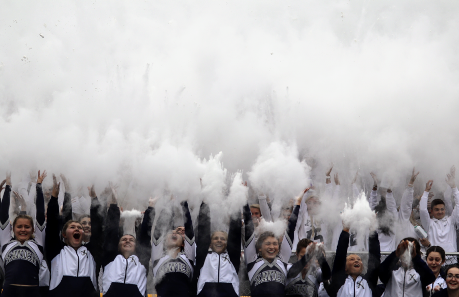 The student section and the cheerleaders throw baby powder at the beginning of the homecoming game on October 5. 