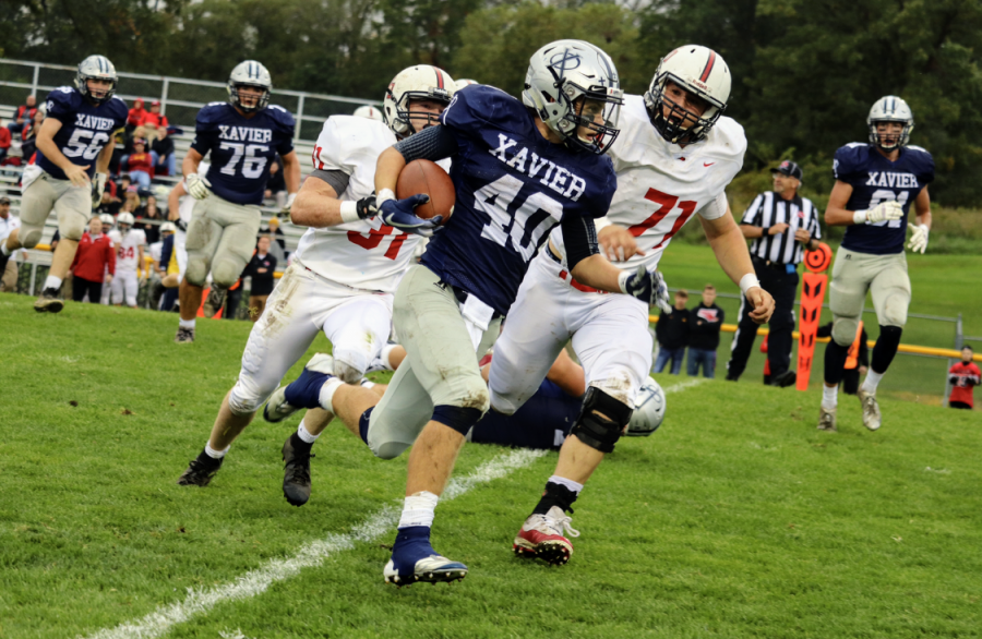 Braden Stovie (#40) runs with the ball during the game against Western Dubuque. Xavier went on to win 35-0. 