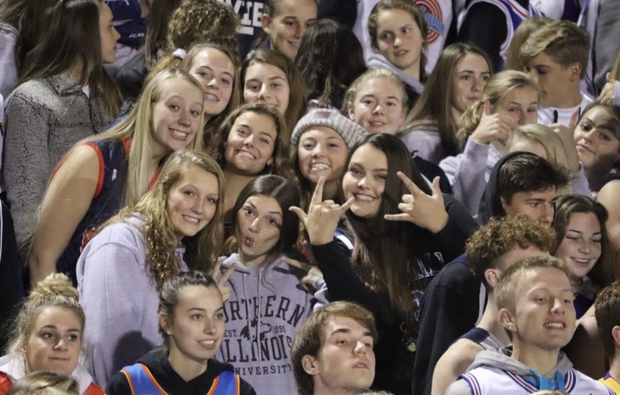 A group of juniors celebrate during a home football game game against Pella. 