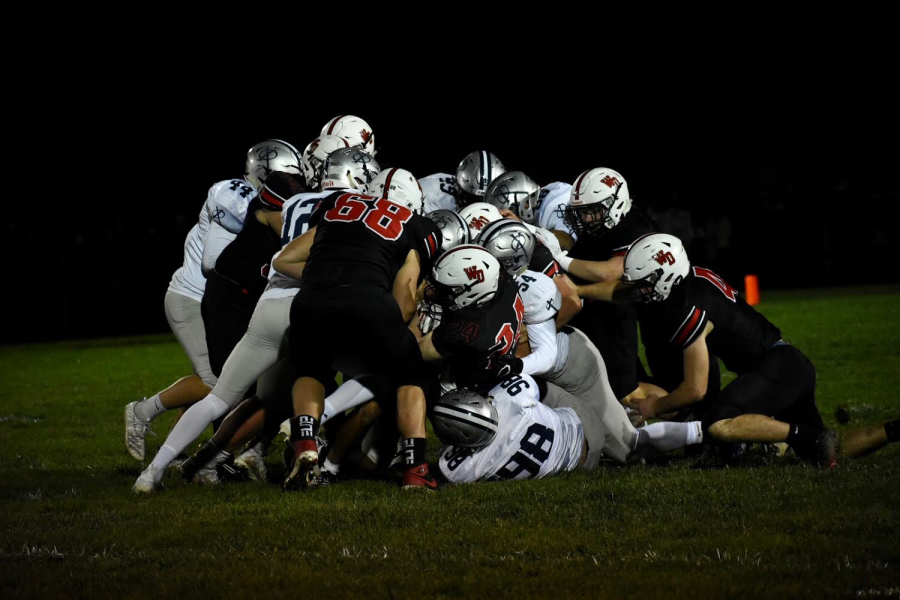 Saints fight to recover a fumble during an intense 4th quarter against Western Dubuque.  